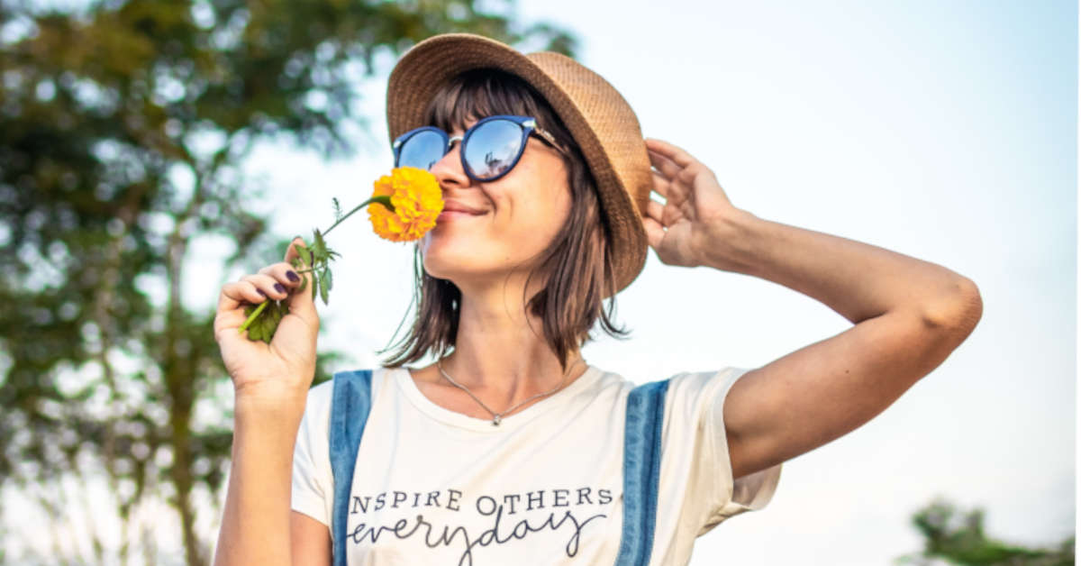 woman smelling flower