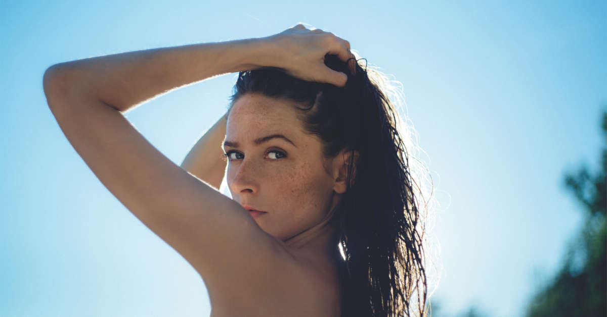 girl holding hair sun