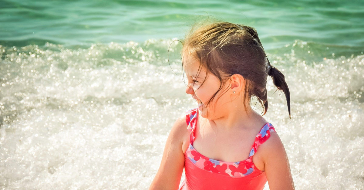 kid on the water smiling