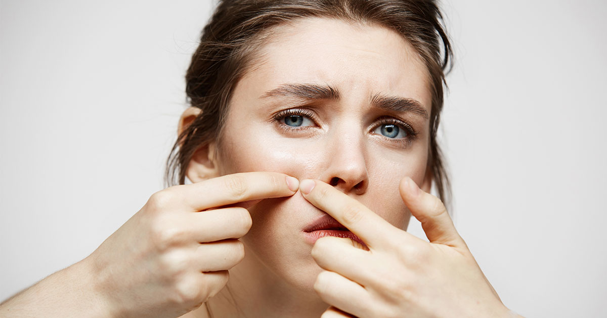 woman popping zit
