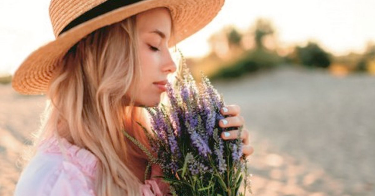 woman smeeling flowers