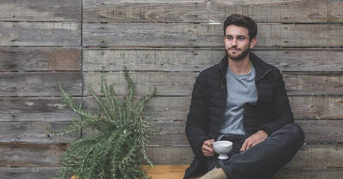 man sitting drinking coffee